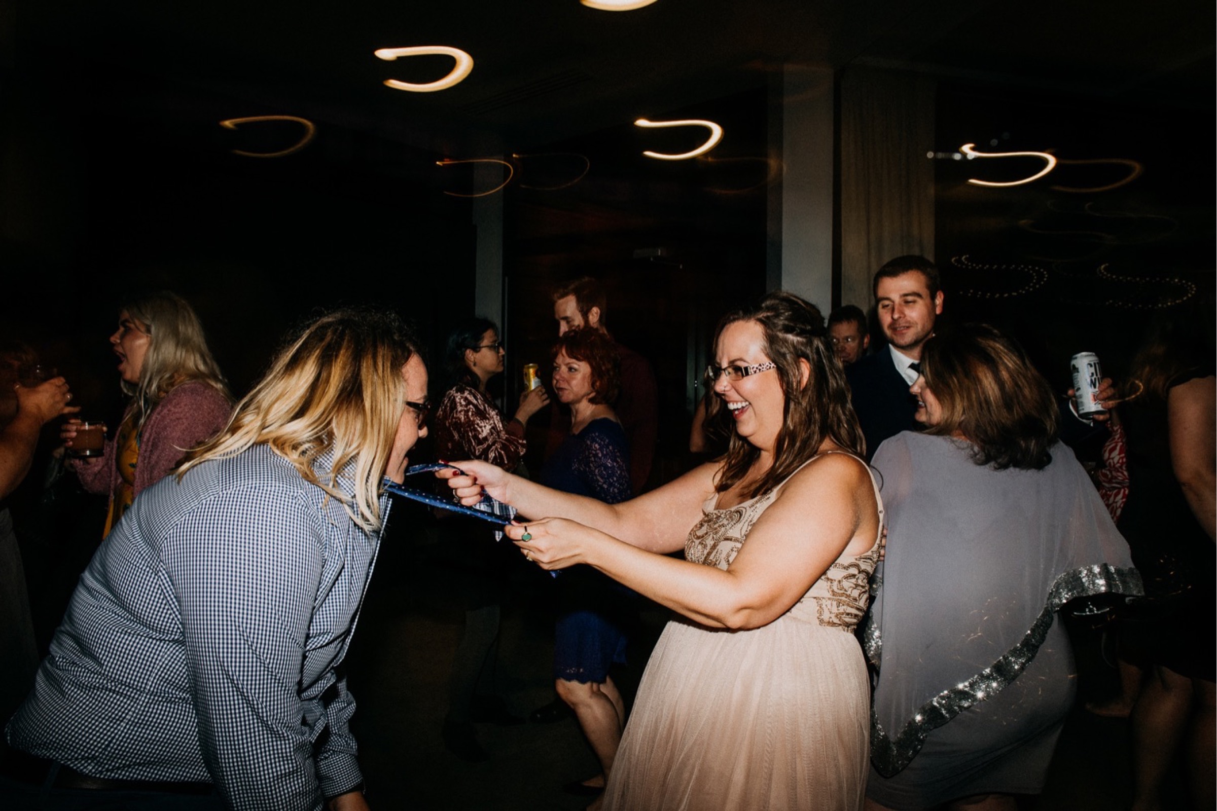 Guests dance and have fun during the reception portion of the wedding day timeline