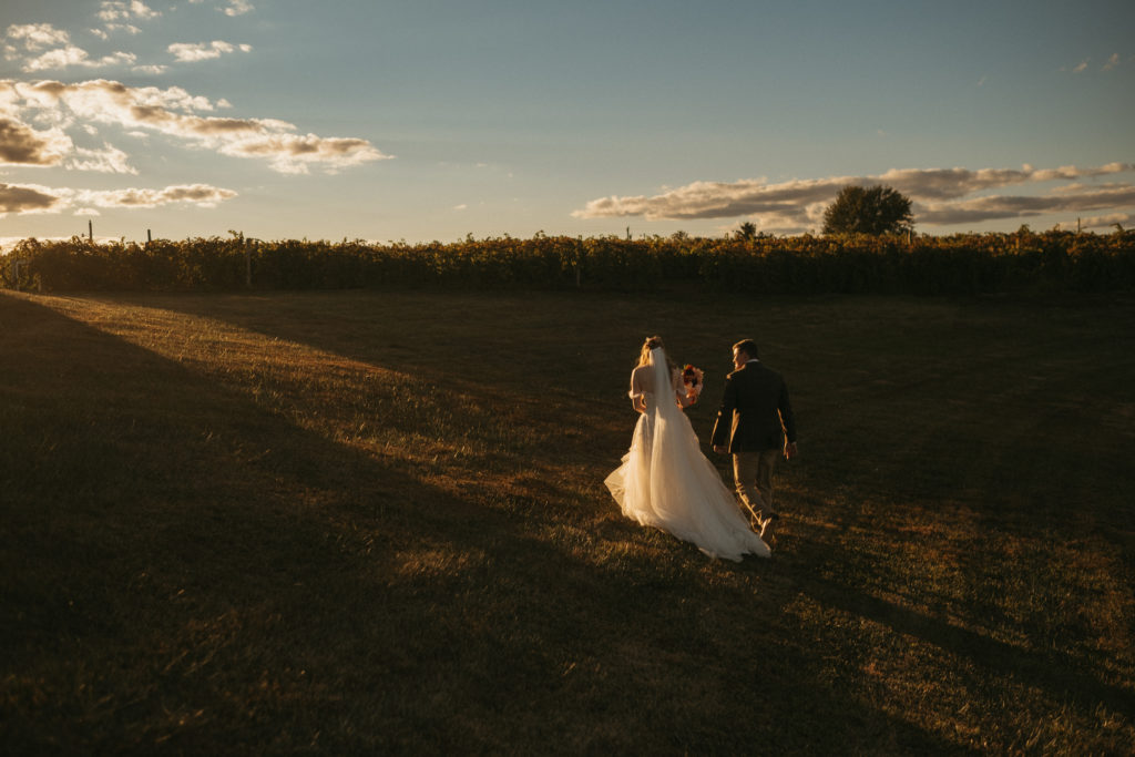 photo of a couple who are going to elope in missouri in a field at sunset