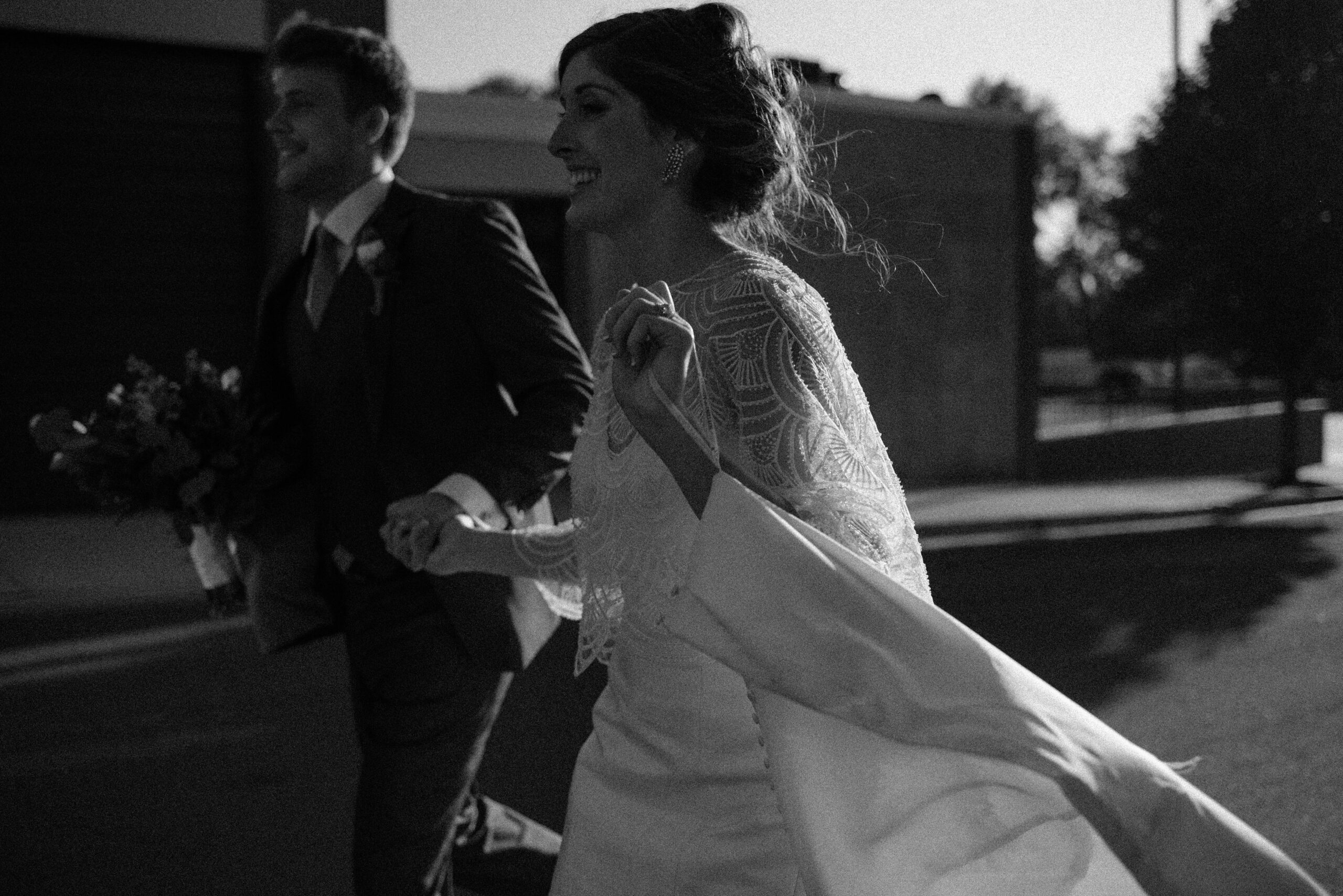 a couple excitedly runs down the street after their elopement
