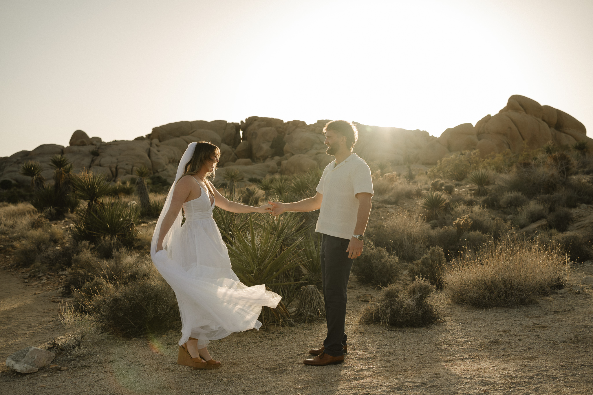 candid photo of a couple eloping in Joshua Tree National Park at sunset